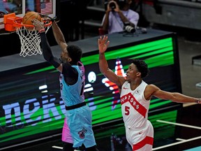 Miami Heat's Bam Adebayo dunks the ball past Raptors' Stanley Johnson during the first half at American Airlines Arena on Wednesday, Feb. 24, 2021.
