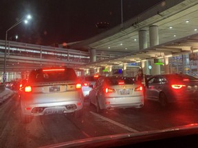 Vehicles outside Terminal One at Pearson airport on Sunday, Feb. 21, 2021 ahead of the start of the mandatory three-day quarantine for passengers returning from non-essential travel.