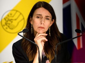 New Zealand Prime Minister Jacinda Ardern listens to media questions in Wellington, Sunday, Feb. 14, 2021.