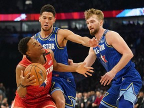 Team Giannis guard Kyle Lowry, left, of the Raptors drives against Team LeBron forward Domantas Sabonis, right, of the Pacers and Devin Booker of the Suns during the 2020 NBA All-Star Game at United Center in Chicago, Feb. 16, 2020.