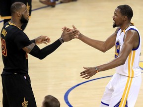 Kevin Durant of the Golden State Warriors shakes hands with LeBron James of the Cleveland Cavaliers on June 12, 2017 in Oakland, California.