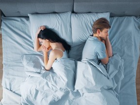 Quarrelling Young Couple in the Bed, Young People Lying Turned Away From Each other and Lay on Their Sides Holding Grudges and Being Offended