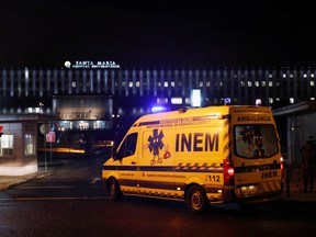 An ambulance with a COVID-19 patient is seen entering Santa Maria hospital.