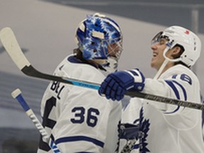 Maple Leafs goalie Jack Campbell (left) is congratulated by Mitch Marner after picking up a shutout against the Edmonton Oilers on Saturday night at Rogers Place. Marner had a goal and an assist in the game.