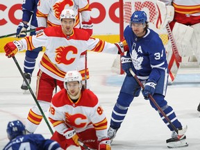 Calgary Flames' holds Maple Leafs' Auston Matthews during NHL action at Scotiabank Arena on Monday, Feb. 22, 2021 in Toronto.