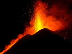 Large streams of red hot lava shoot into the night sky as Mount Etna, Europe's most active volcano, continues to erupt, February 22, 2021.