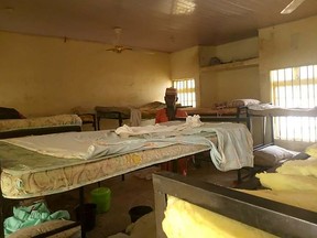 A man stands in the deserted school dormitory after bandits invaded and took away over 300 schoolgirls in Jangede, Nigeria, on February 26, 2021.