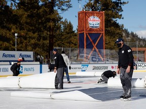 NHL workers cover the ice following the first period between the Vegas Golden Knights and the Colorado Avalanche at Lake Tahoe at the Edgewood Tahoe Resort on February 20, 2021 in Stateline, Nevada.