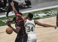 Bucks forward Giannis Antetokounmpo (right) and Raptors forward Pascal Siakam battle for a rebound in Milwaukee on Tuesday night.