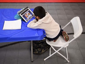 A child attends an online class at a learning hub inside the Crenshaw Family YMCA during the Covid-19 pandemic on February 17, 2021 in Los Angeles.