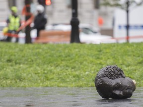 The head of a statue of Sir John A. Macdonald is shown torn down following a demonstration in Montreal, Saturday, Aug. 29, 2020, where they protested to defund the police with a goal to end all systemic racism within all sectors of the Canadian government.