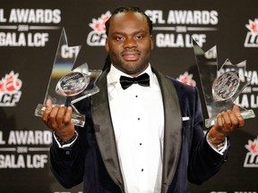 Solomon Elimimian with Most Outstanding Player and Most Outstanding Defensive Player trophies.