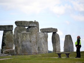 A security officer patrols around the perimeter Stonehenge stone circle, near Amesbury, Britain June 20, 2020.