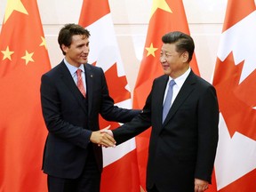 In this Aug. 31, 2016 file photo, Chinese President Xi Jinping shakes hands with Prime Minister Justin Trudeau ahead of their meeting at the Diaoyutai State Guesthouse in Beijing, China.