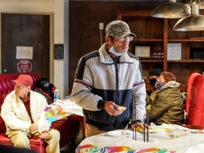 Mike Biesert eats a sandwich while taking shelter at Gallery Furniture store which opened its doors and transformed into a warming station after winter weather caused electricity blackouts in Houston, Wednesday, Feb. 17, 2021.