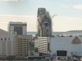 The Trump Plaza Casino collapses after a controlled demolition in Atlantic City, N.J., Wednesday, Feb. 17, 2021.