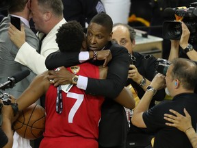 Toronto Raptors president Masai Ujiri (right) hugs guard Kyle Lowry (7).