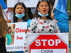 In this file photo taken on July 5, 2020, demonstrators staged a protest across the street from the Chinese consulate in Calgary, demanding China stop the persecution of the Uyghur people and the freedom of imprisoned Canadians.