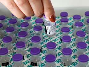 A health worker prepares a dose of the Pfizer-BioNtech COVID-19 vaccine at Clalit Health Services in the Israeli city of Petah Tikva, on February 1, 2021.