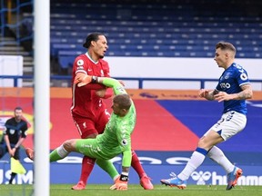 Liverpool’s Virgil van Dijk collides with Everton’s Jordan Pickford back in October 2020. The teams clash again on Saturday. Reuters