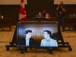 Marc Kielburger, screen left, and Craig Kielburger, screen right,  appear as witnesses via videoconference during a House of Commons finance committee in the Wellington Building in Ottawa, July 28, 2020.