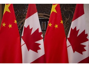 In this file photo taken on Dec. 5, 2017, shows Canadian and Chinese flags taken prior to a meeting with Canada's Prime Minister Justin Trudeau and China's President Xi Jinping at the Diaoyutai State Guesthouse in Beijing.