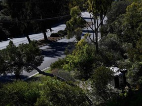 The vehicle driven (R bottom) by golfer Tiger Woods lies on its side in Rancho Palos Verdes, California, on February 23, 2021, after a rollover accident.