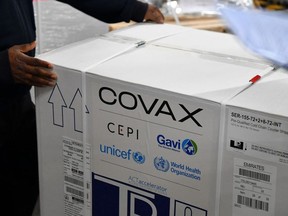A carton box of a Covishield vaccine developed by Pune based Serum Institute of India (SII) is unloaded at the Mumbai airport on February 24, 2021, as part of the Covax scheme, which aims to procure and distribute inoculations fairly among all nations.