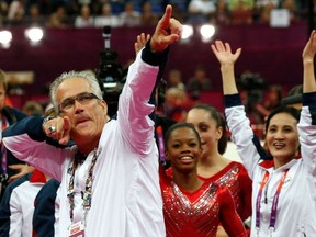 In this file photo taken on July 31, 2012, US women gymnastics team's coach John Geddert celebrates with the rest of the team after the US  won gold in the women's team artistic gymnastics event at the London Olympic Games.