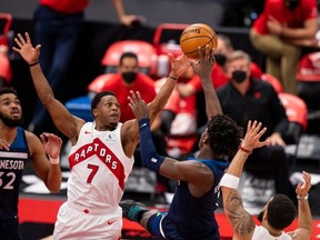 Toronto Raptors guard Kyle Lowry attempts to block Minnesota Timberwolves forward Anthony Edwards during the fourth quarter of a game between the Toronto Raptors and the Minnesota Timberwolves at Amalie Arena.