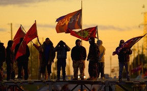 Protesters stand on a barricade re-erected with part of a hydro tower dropped across Argyle Rd. in Caledonia on May 23, 2006.