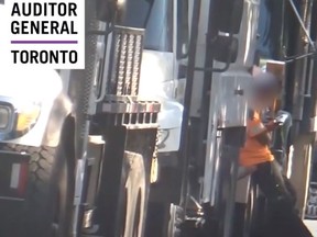 A city-contracted worker on his mobile phone during a Toronto Auditor General's follow-up report on issues with city tree maintenance crews.