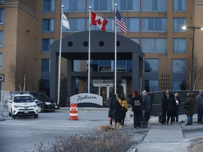 A group of protesters rally out front of the Radisson hotel on Dixon Rd., where travellers are forced to quarantine after arriving at nearby Pearson International Airport, on Thursday Feb. 11, 2021.