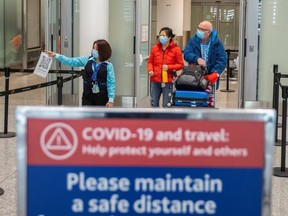 Travellers from an international flight are directed to the COVID-19 testing at Toronto Pearson International Airport in Mississauga, Feb. 24, 2021.