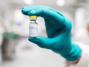 A lab worker holds a vial of Johnson & Johnson's Janssen coronavirus disease (COVID-19) vaccine candidate in an undated photograph.