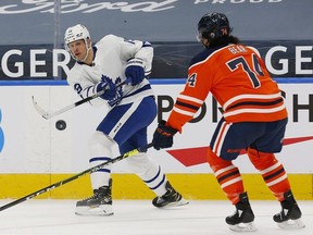 Toronto Maple Leafs forward Jason Spezza makes a pass in front of Edmonton Oilers defensemen Ethan Bear during the second period at Rogers Place.