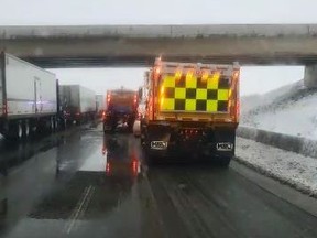 Snowplows on Hwy. 401 in Mississauga on Monday, Feb. 22, 2021.