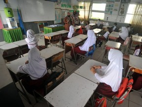 Students attend a learning session at a school in Padang, West Sumatra province, Indonesia, in this photo taken January 4, 2021 by Antara Foto.