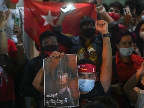 A protester holds an image of the detained Myanmar civilian leader Aung San Suu Kyi during a demonstration condemning the military coup outside the Myanmar embassy in Bangkok on Feb. 4, 2021, days after Myanmar's security forces detained Suu Kyi and the country's president.