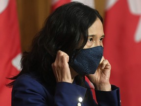 Chief Public Health Officer Theresa Tam removes her mask as she arrives for a news conference Friday, October 2, 2020 in Ottawa.