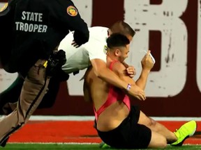 A man in a thong is tackled on the field during the fourth quarter of the Super Bowl in Tampa, Feb. 7, 2021.