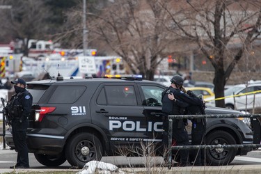 Two police officers embrace after a gunman opened fire at a King Soopers grocery store on March 22, 2021 in Boulder, Colorado. Dozens of police responded to the afternoon shooting in which at least one witness described three people who appeared to be wounded, according to published reports.  (Photo by Chet Strange/Getty Images)