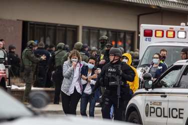 Health-care workers walk out of a King Sooper's Grocery store after a gunman opened fire on March 22, 2021 in Boulder, Colorado. Dozens of police responded to the afternoon shooting in which at least one witness described three people who appeared to be wounded, according to published reports.  (Photo by Chet Strange/Getty Images))