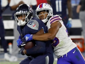 Jonnu Smith of the Tennessee Titans runs with the ball while being tackled by Josh Norman of the Buffalo Bills in the second quarter at Nissan Stadium on October 13, 2020 in Nashville, Tennessee.