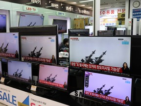 TV screens show a news program reporting about North Korea's missiles with file images at an electronic shop on March 25, 2021 in Seoul, South Korea.