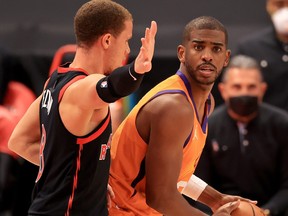 Chris Paul #3 of the Phoenix Suns is defended by Malachi Flynn #8 of the Toronto Raptors.