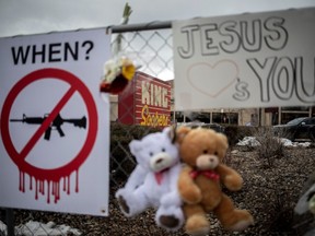 Memorials with signs, teddy bears and flowers are left on the fencing surrounding King Sooper's grocery store where a gunman opened fire, killing 10 people, including a police officer.