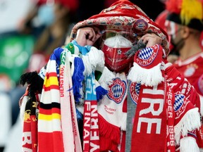 A Munich fan wearing scarves and protective gear is pictured at the Feb. 11, 2021  Club World Cup final between Bayern Munich and Mexico's  Tigres UANL in Al Rayyan, Qatar.