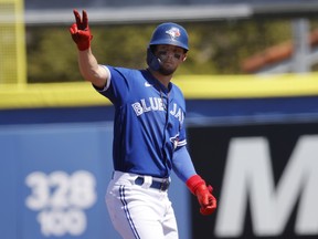 Toronto Blue Jays third baseman Cavan Biggio reacts to the dugout as he hits a RBI double during spring training.