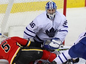 Calgary Flames Mark Giordano collides with goalie Jack Campbell of the Toronto Maple Leafs